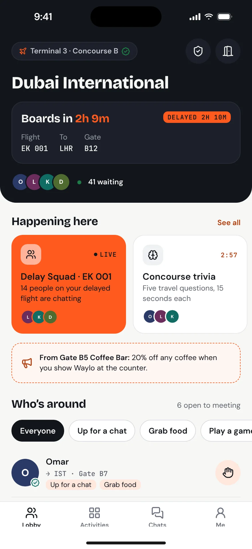 Lobby at Dubai International showing a delayed flight, live activities and people nearby